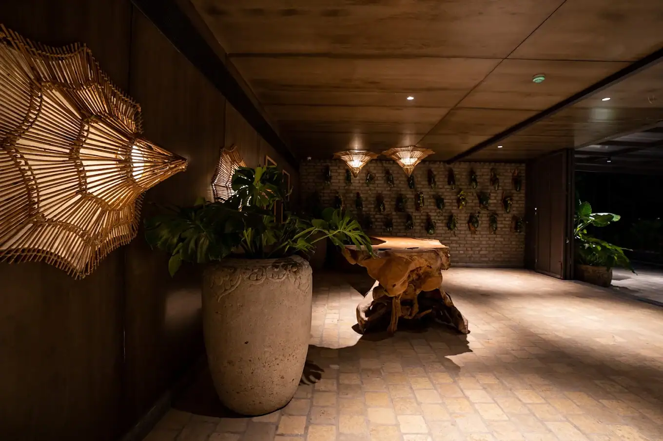 Photograph from Makau's own venue gallery: the double-height atrium, terracotta jaali and hanging raffia birds overhead.